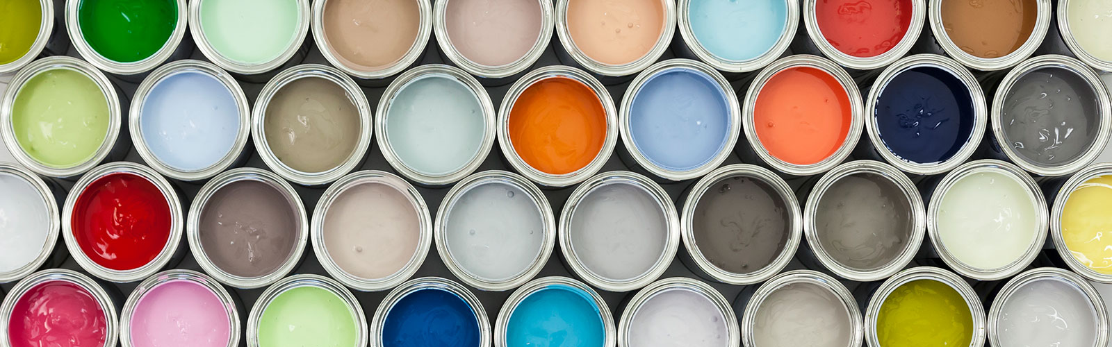 Paint cans lined up on shelf