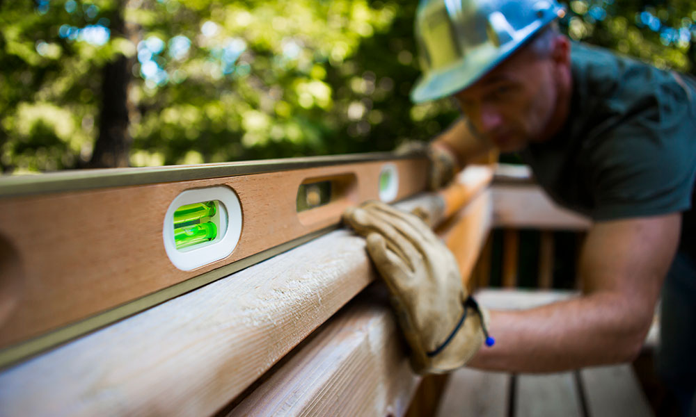 Worker using a level